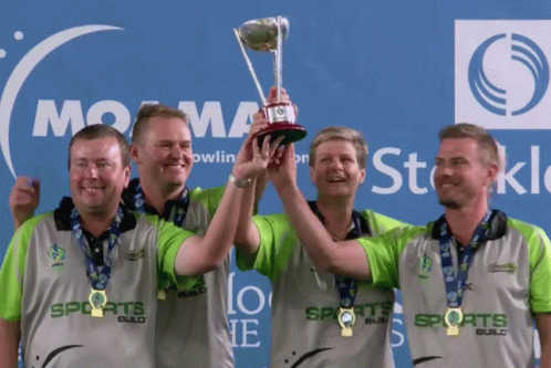 Men Holding Trophy In Front Of Sports Logo GIF
