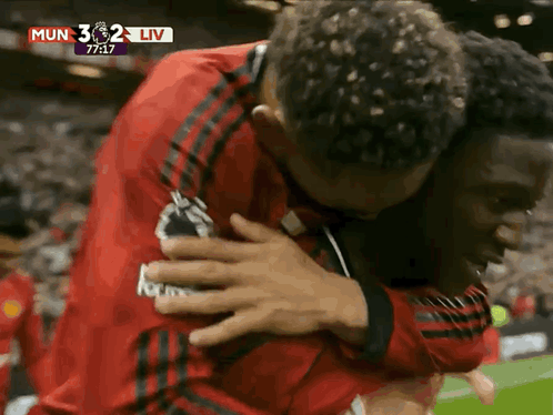 Men Hugging on Soccer Field