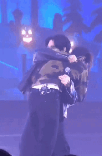 Men Hugging On Stage GIF