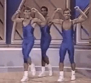 Men in Blue Leotards Flexing and Dancing