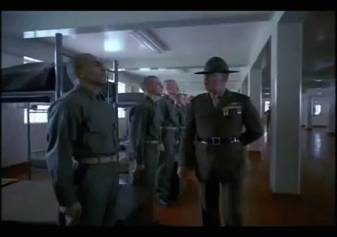 Men In Military Uniforms In Hallway GIF