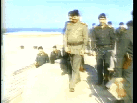 Men in Military Uniforms Walking on Beach