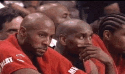 Men in Red Shirts Sitting in Stadium