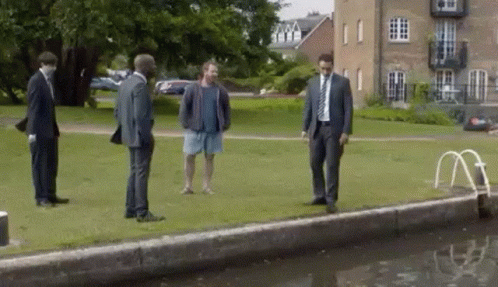 Men In Suits And Shorts By Water GIF