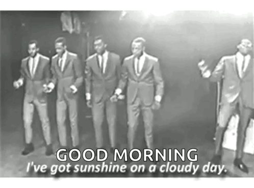 Men in Suits Singing Into Microphones