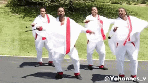 Men In White And Red Dancing On Street GIF