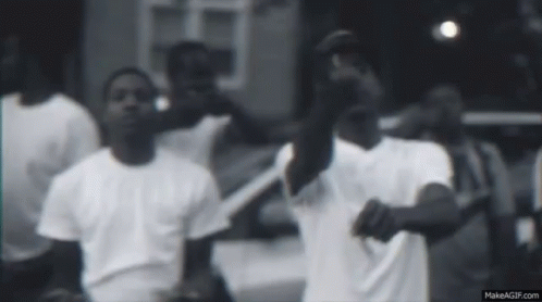 Men In White Shirts Standing In Front Of Car GIF