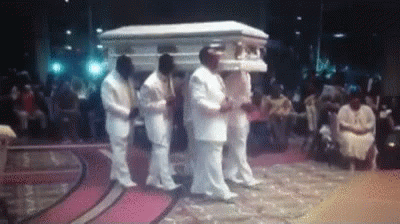 Men In White Suits Carrying Coffin GIF
