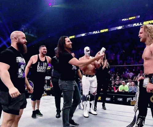 Men In Wrestling Ring With Join Dark Order Shirt GIF