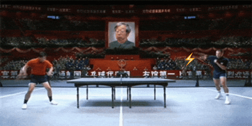 Men Playing Ping Pong in Front of Crowd