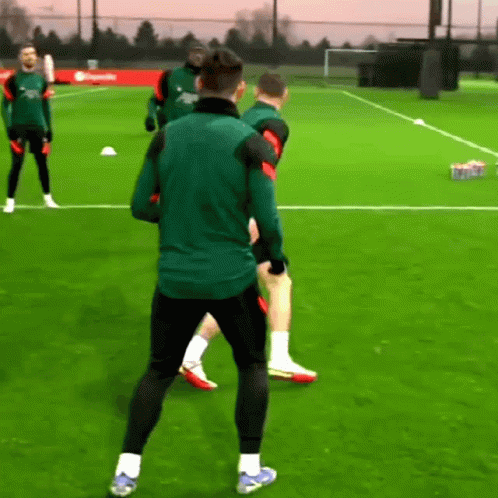 Men Playing Soccer, One in Green Nike Jacket