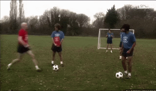 Men Playing Soccer with Goal