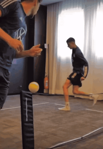 Men Playing Soccer With TF Sports Net