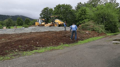 Men Raking Mulch On Roadside GIF