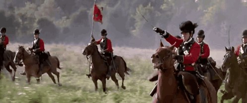 Men Riding Horses With Flag GIF