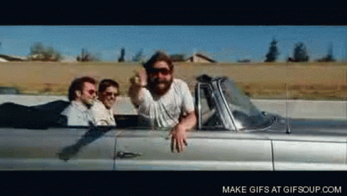 Men Riding Silver Convertible Giving Middle Finger GIF