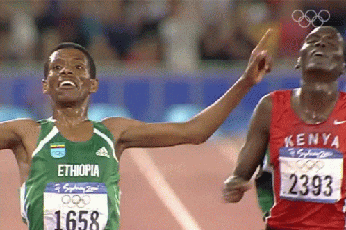 Men Running In Green Ethiopia And Red Kenya Shirts GIF