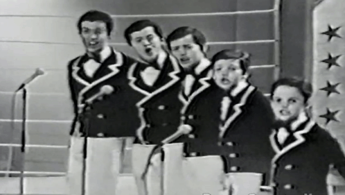 Men Singing Into Microphones On Star Wall GIF