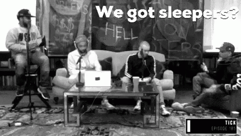 Men Sitting Around Microphone