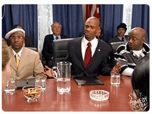Men Sitting Around Table With Water Pitcher And Ashtray GIF