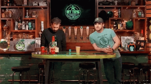 Men Sitting at Bar Watching TV