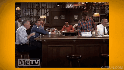 Men Sitting at Bar with Metv Logo