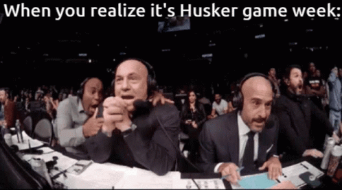 Men Sitting at Table Husker Game Week Realization