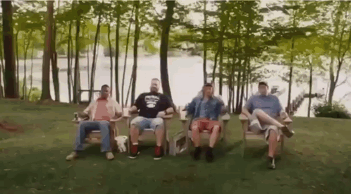 Men Sitting in Chairs by Lake