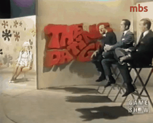 Men Sitting in Front of Wall Saying The Day