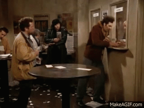 Men Standing Around Table GIF