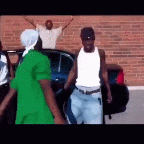 Men Standing Beside Car And Brick Wall GIF