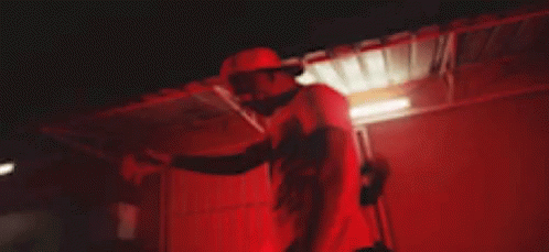 Men Standing in Dark Room With Red Lights