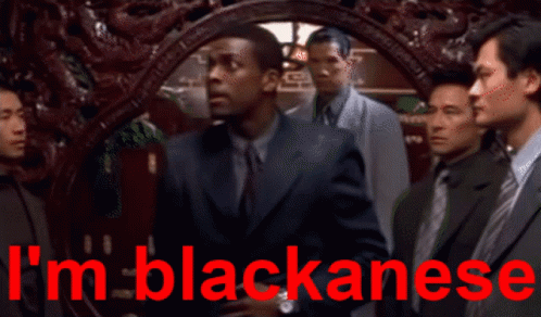 Men Standing in Front of Blackanese Sign