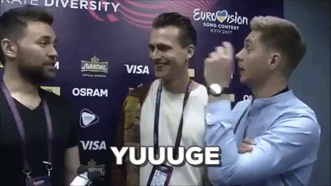 Men Standing in Front of Eurovision Wall