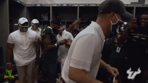 Men Standing In Locker Room With Bullpen Logo GIF