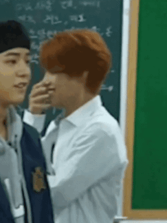 Men Standing Next To Each Other In Front Of Blackboard GIF