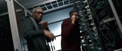 Men Standing Next to Each Other in Server Room