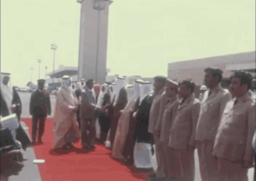 Men Standing on Red Carpet