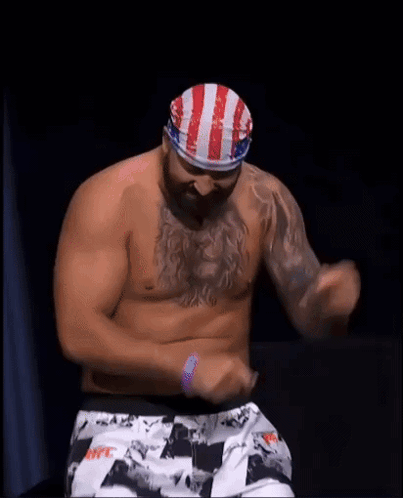 Men Surrounding Bald Man In Boxing Ring GIF
