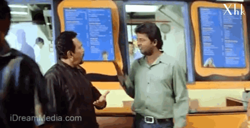 Men Talking In Front Of XHK Menu GIF