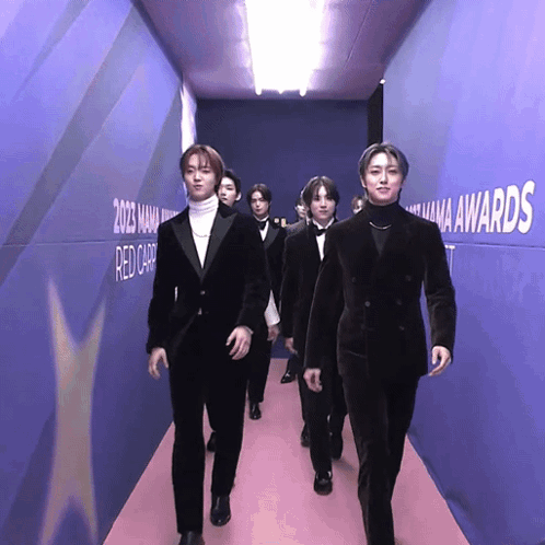 Men Walking Down Hallway With Mana Awards