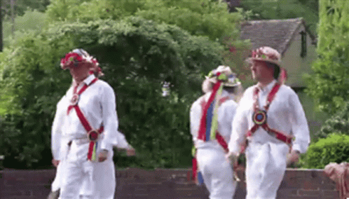 Men Walking In Line Wearing White Shirts And Hats GIF