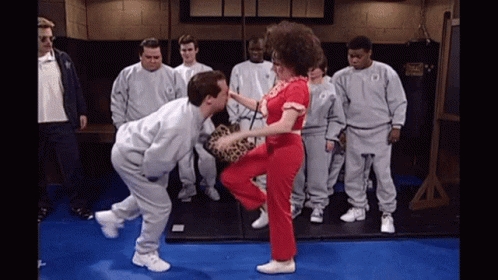 Men Watching Woman Kick Man at Everlast Bag
