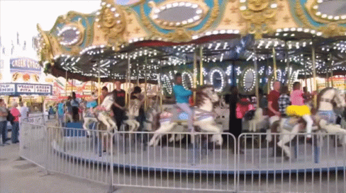 Merry Go Round With Eagle Claw Sign GIF