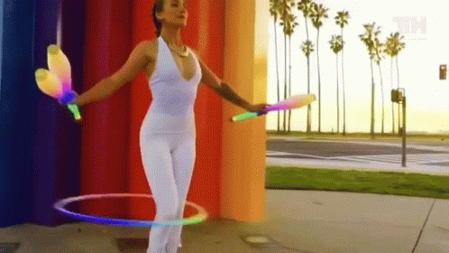 Mesmerizing Circus Juggling Hula Hoop Stunt GIF
