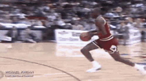 Michael Jordan Is Dribbling A Basketball On A Court . GIF