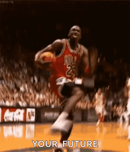 Michael Jordan Is Jumping In The Air While Holding A Basketball In His Hand . GIF