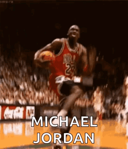 Michael Jordan Is Jumping In The Air With A Basketball In His Hand . GIF