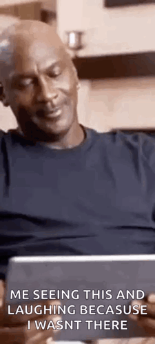 Michael Jordan Is Sitting On A Couch Laughing Because He Wasn 'T There . GIF