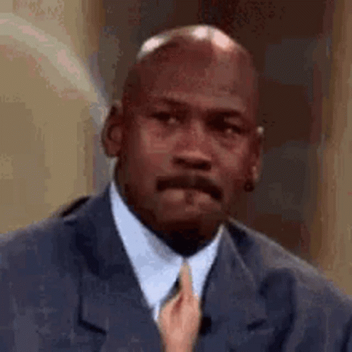 Michael Jordan Is Wearing A Suit And Tie While A Woman Holds His Tie . GIF